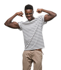 Fototapeta premium Young african american man wearing glasses and navy t-shirt showing arms muscles smiling proud. Fitness concept.