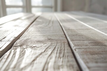 A close up view of a wooden table with a window in the background. This image can be used for various purposes