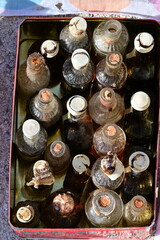 Old soda bottles in a wooden box on a flea market in Spain.