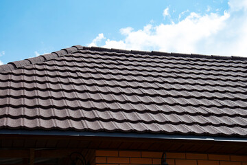 Composite roof tile on house against blue sky