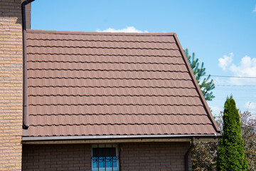 Composite roof tile on house against blue sky