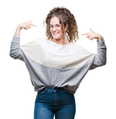 Beautiful brunette curly hair young girl wearing glasses over isolated background looking confident...