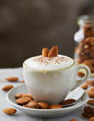 Plant-based almond cappuccino with almond garnish on top of the almond milk foam
