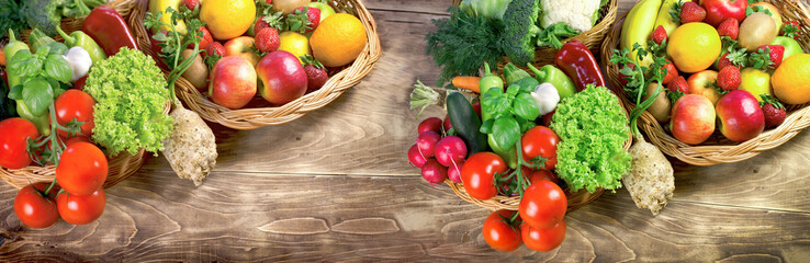 Heap of fresh, organic fruits and vegetables in wicker baskets on table - 709688829