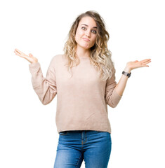Beautiful young blonde woman wearing sweatershirt over isolated background clueless and confused...