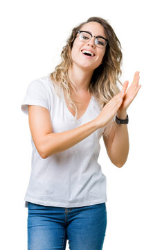 Beautiful young blonde woman wearing glasses over isolated background Clapping and applauding happy and joyful, smiling proud hands together
