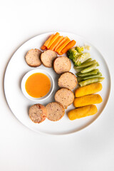 Beef Galantine or Galantin Sapi, De Boned Stuffed Meat Served with Steamed Mix Veggies , potato nuggets, and homemade sambal sauce