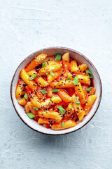 Tteokbokki or topokki, Korean street food, spicy rice cakes in red pepper gochujang sauce, shot from above