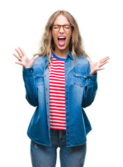 Beautiful young blonde woman wearing glasses over isolated background celebrating mad and crazy for...