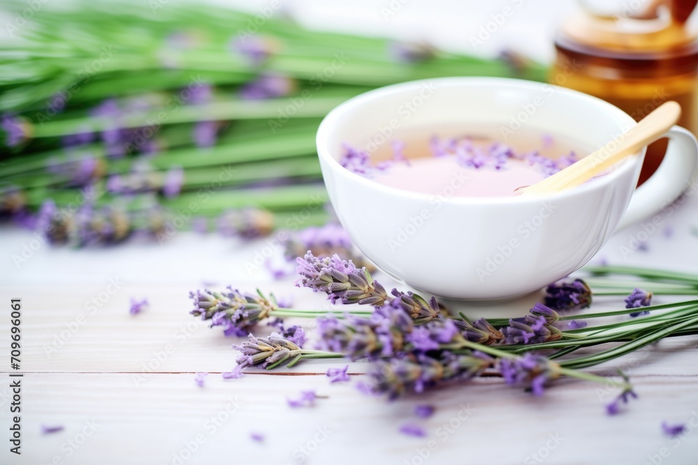 Canvas Prints fresh lavender sprigs beside purple-hued tea in cup