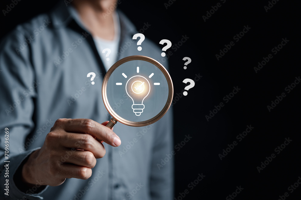 Poster Hand with Ideas focus to Light Bulb which among Question icon. Target solution target, successful business and thinking solution strategy concept.