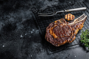 BBQ Grilled Tomahawk or rib eye with bone beef steak. Black background. Top view. Copy space