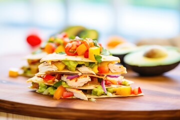 colorful chicken quesadilla slices with avocado and tomato salsa