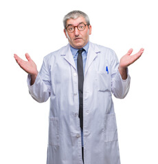 Handsome senior doctor, scientist professional man wearing white coat over isolated background clueless and confused expression with arms and hands raised. Doubt concept.