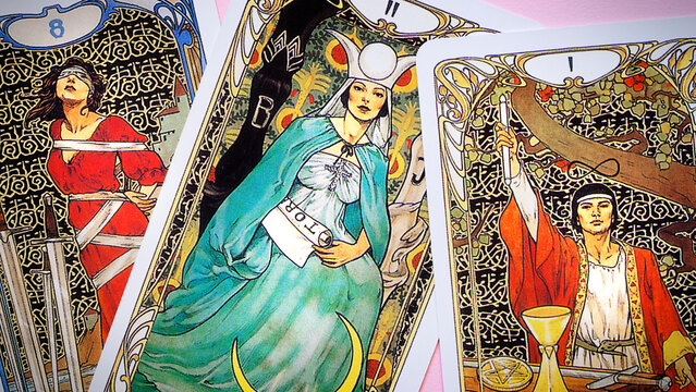 Blurred View of Golden tarot cards background, esoteric concept, fortune telling and predictions, Moscow, Russia - August 2021.