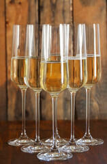 Glasses of champagne on wooden background