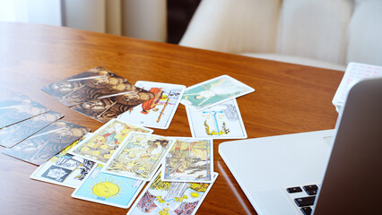 Fototapeta na wymiar Tarot card reader arranges cards in a card spread. Fortune-telling concept