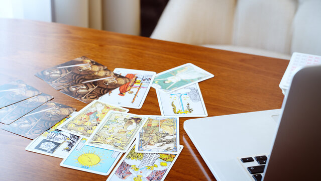 Tarot card reader arranges cards in a card spread. Fortune-telling concept