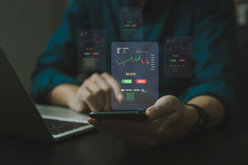 Hand using mobliel phone Finance and business investment concept. Stock and crypto investment funds.Businessman analyzing or trading Forex graphs of financial data candlestick chart.