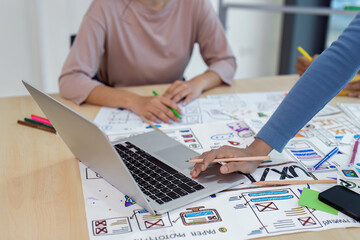 Close up ux developer and ui designer using laptop for brainstorming interface wireframe design....