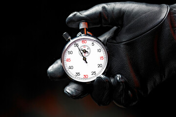 Close-Up 4K Ultra HD Image of Stopwatch in Hand with Black Glove