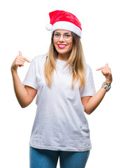 Young beautiful woman wearing christmas hat over isolated background looking confident with smile...