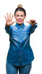 Naklejka premium Young beautiful woman over isolated background showing and pointing up with fingers number six while smiling confident and happy.