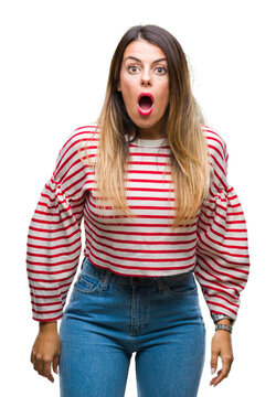 Young beautiful woman casual stripes winter sweater over isolated background afraid and shocked with surprise expression, fear and excited face.