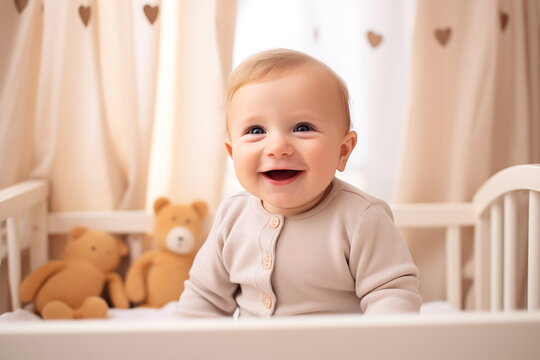 Children toddler in baby crib smiling and laughing. Cute 6 months toddler photo in light interior baby room. Bright solid clothes. Happy baby, good sleep, healthy. Baby care, happy parenting.