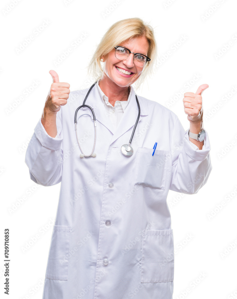 Poster Middle age blonde doctor woman over isolated background success sign doing positive gesture with hand, thumbs up smiling and happy. Looking at the camera with cheerful expression, winner gesture.