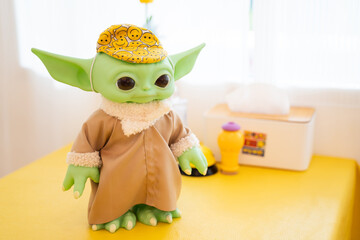 Naklejka premium Bangkok, Thailand, January 12, 2024. Close-up of Green Yoda from Star Wars figure on tabletop