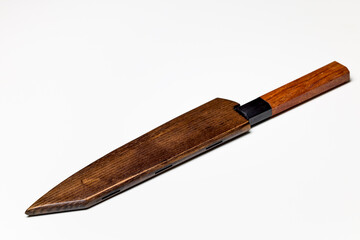 Professional kitchen knife next to a wooden sheath