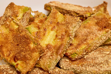 a bowl with slices of cooked breaded zucchini.