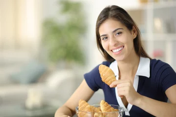 Fotobehang Happy woman posing holding bakery at home © Antonioguillem