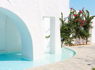 White stone building with pool in yard