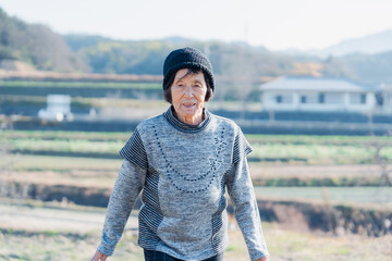 田舎の道を散歩する高齢の女性 © maroke