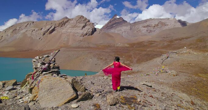 Nepali female actress feels air at World's highest altitude Lake Nepal Tilicho, Drone shot reveals landscape of Annapurna region, pink dress flaunting in Mountain 4K