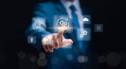 RPA (Robotic Process Automation system) concept, Businessman touch virtual screen of RPA icons for Robotic process automation technology to automate business tasks with AI.