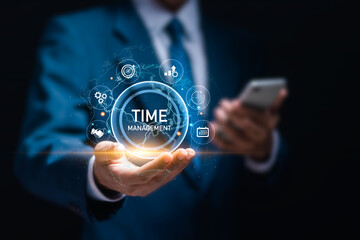 Time management concept. Businessman hold virtual time management word to work planning for increases efficiency and reduces work time. Business project planning.