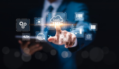 SaaS (software as a service) concept, Businessman touch virtual screen of SaaS icons for software services on cloud system. Internet and networking technology.
