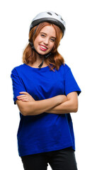Young beautiful woman wearing cyclist helmet over isolated background happy face smiling with crossed arms looking at the camera. Positive person.