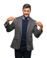 Fototapeta premium Young handsome business man over isolated background looking confident with smile on face, pointing oneself with fingers proud and happy.