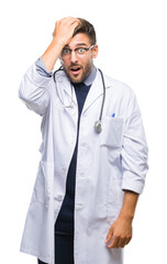 Young handsome doctor man over isolated background surprised with hand on head for mistake,...