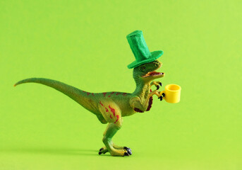 Funny dinosaur in green hat with beer  celebrating St. Patrick's day.
