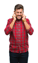 Young handsome man over isolated background covering ears with fingers with annoyed expression for the noise of loud music. Deaf concept.