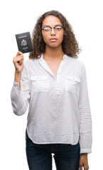 Young hispanic woman holding passport of United States of America with a confident expression on...