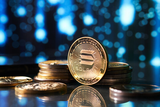 Closeup of golden Solana cryptocurrency surrounded by more coins