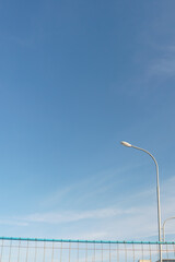 A city lantern on a blue sky background on a sunny day. The concept of peace and quiet, peace and inner harmony.