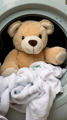 Cute teddy bear sitting in washing machine, close-up	