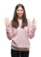 Young beautiful hispanic woman wearing a sweater showing and pointing up with fingers number eight while smiling confident and happy.